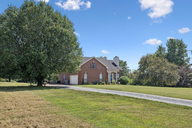 131 E Robertson Rd, Castalian Springs, TN 37031 - view of front of home with brick siding, a chimney, a front lawn, and gravel driveway