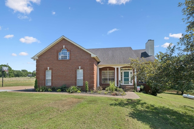 131 E Robertson Rd, Castalian Springs, TN 37031 - traditional home with brick siding, a front lawn, and a chimney