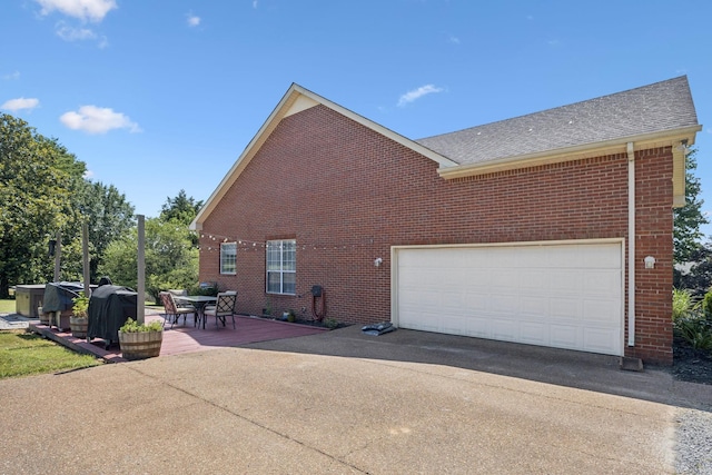 131 E Robertson Rd, Castalian Springs, TN 37031 - view of home's exterior featuring brick siding, driveway, and roof with shingles