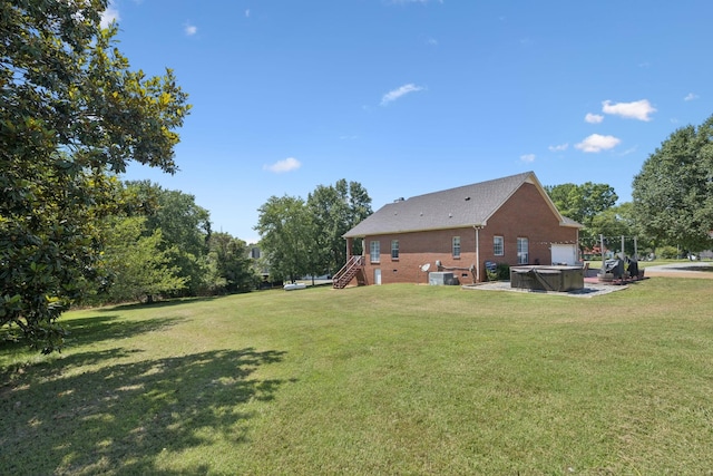 131 E Robertson Rd, Castalian Springs, TN 37031 - view of grassy yard with a hot tub and a garage