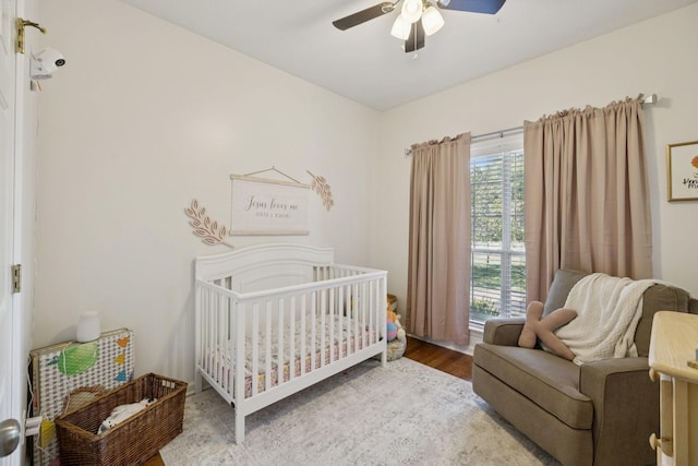 131 E Robertson Rd, Castalian Springs, TN 37031 - bedroom with a crib, wood finished floors, and ceiling fan