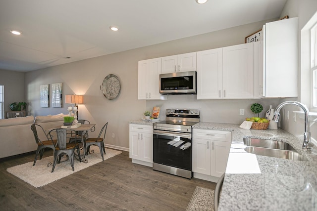 225 Tara Ct Unit 225, Columbia, TN 38401 - kitchen featuring appliances with stainless steel finishes, white cabinetry, dark wood-style flooring, open floor plan, and recessed lighting