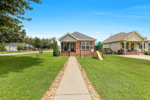 397 W Mcglothlin St, Portland, TN 37148 - bungalow-style house featuring a porch, brick siding, a front lawn, and a playground