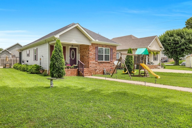 397 W Mcglothlin St, Portland, TN 37148 - view of front of property with a playground, a porch, and brick siding