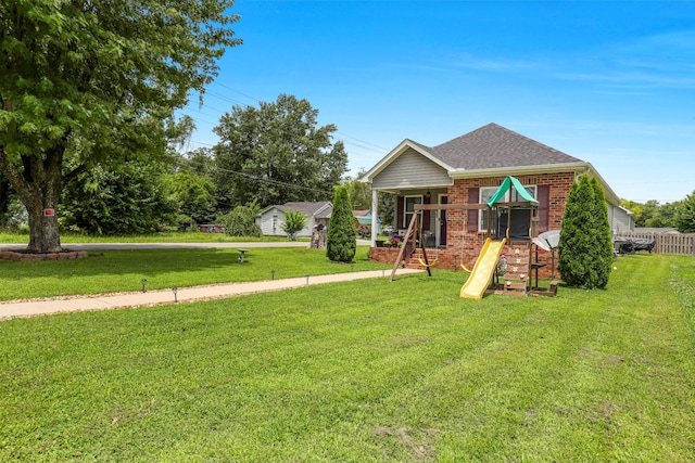 397 W Mcglothlin St, Portland, TN 37148 - view of front of property with brick siding, a playground, a front yard, and roof with shingles