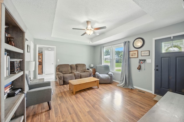 561 Danielle Dr, Clarksville, TN 37042 - living area featuring a textured ceiling, a raised ceiling, light wood-style floors, and a ceiling fan