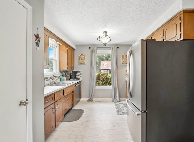 561 Danielle Dr, Clarksville, TN 37042 - kitchen with stainless steel appliances, light marble finish flooring, light countertops, tasteful backsplash, and brown cabinets