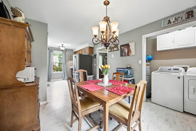 561 Danielle Dr, Clarksville, TN 37042 - dining space with washing machine and clothes dryer, a chandelier, and light marble finish floors