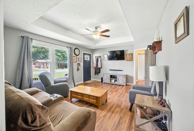 561 Danielle Dr, Clarksville, TN 37042 - living area featuring a ceiling fan, a tray ceiling, a textured ceiling, and light wood finished floors