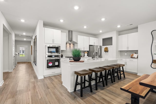 3412 Shigo St, Murfreesboro, TN 37130 - kitchen with stainless steel appliances, an island with sink, a kitchen bar, tasteful backsplash, and wall chimney exhaust hood