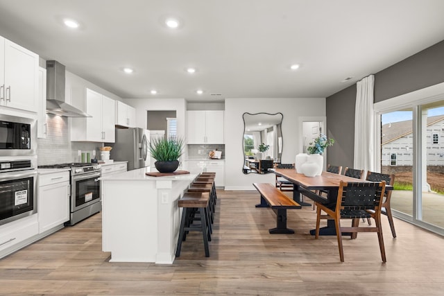 3412 Shigo St, Murfreesboro, TN 37130 - kitchen with appliances with stainless steel finishes, plenty of natural light, wall chimney range hood, a center island, and recessed lighting