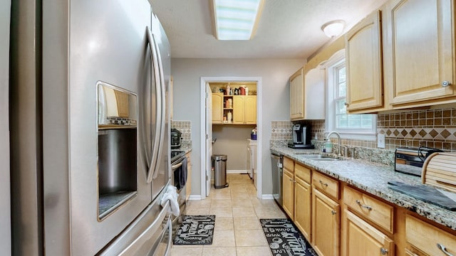 1006 Summer Ln, Pleasant View, TN 37146 - kitchen featuring appliances with stainless steel finishes, decorative backsplash, light brown cabinets, light tile patterned floors, and light stone countertops