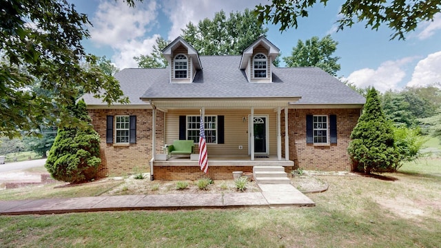 1006 Summer Ln, Pleasant View, TN 37146 - cape cod home with covered porch, brick siding, a front lawn, and roof with shingles