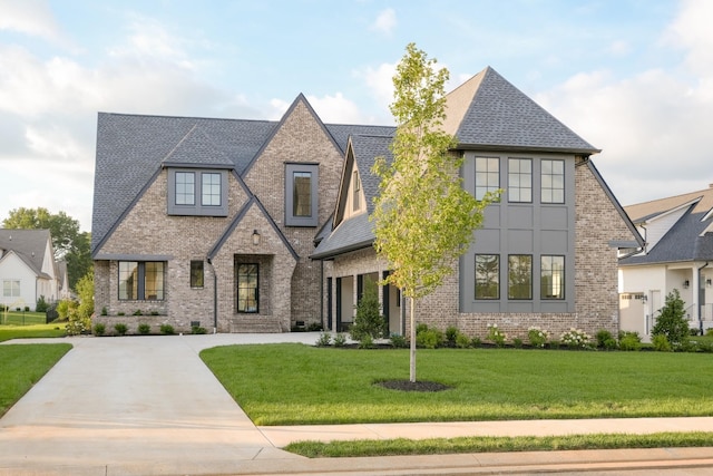 1726 Rigsby Ave, Murfreesboro, TN 37129 - view of front facade with driveway, brick siding, a front yard, and a shingled roof