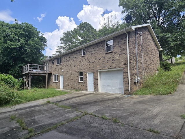213 April Dr, Old Hickory, TN 37138 - view of side of property featuring a garage, a deck, driveway, and brick siding