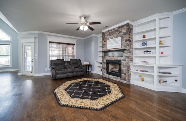 2331 Lionheart Dr, Murfreesboro, TN 37130 - living room featuring a stone fireplace, a ceiling fan, healthy amount of natural light, dark wood-type flooring, and crown molding