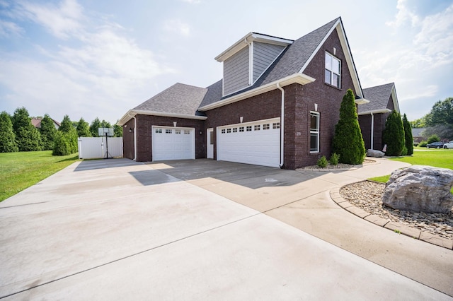 2331 Lionheart Dr, Murfreesboro, TN 37130 - view of home's exterior featuring brick siding, a gate, driveway, a garage, and a shingled roof
