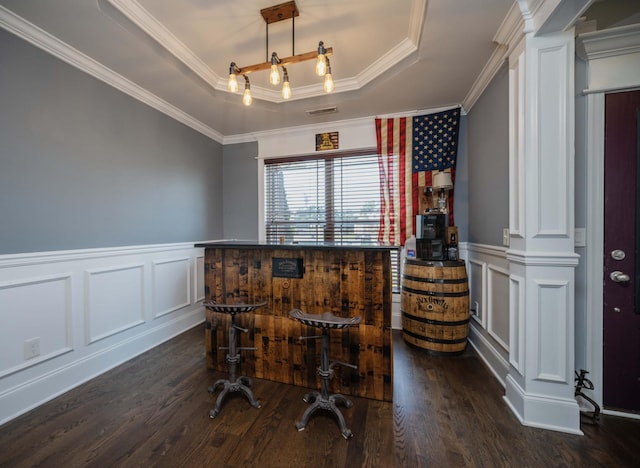 2331 Lionheart Dr, Murfreesboro, TN 37130 - dining area featuring a decorative wall, a raised ceiling, dark wood-style floors, crown molding, and wainscoting