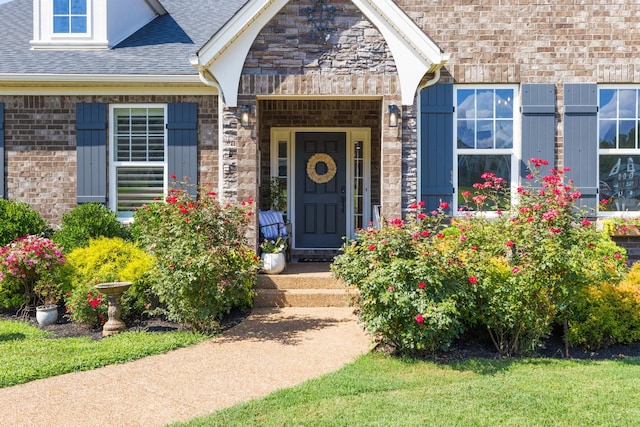 7156 Triple Crown Ln, Fairview, TN 37062 - property entrance featuring a shingled roof, stone siding, and brick siding