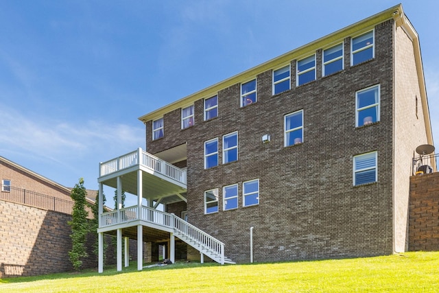 7156 Triple Crown Ln, Fairview, TN 37062 - rear view of house with a yard, stairs, a balcony, and brick siding