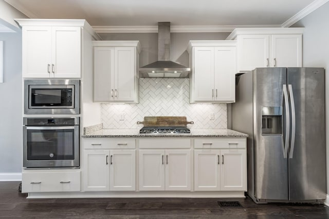 7156 Triple Crown Ln, Fairview, TN 37062 - kitchen with appliances with stainless steel finishes, wall chimney exhaust hood, white cabinets, ornamental molding, and light stone counters