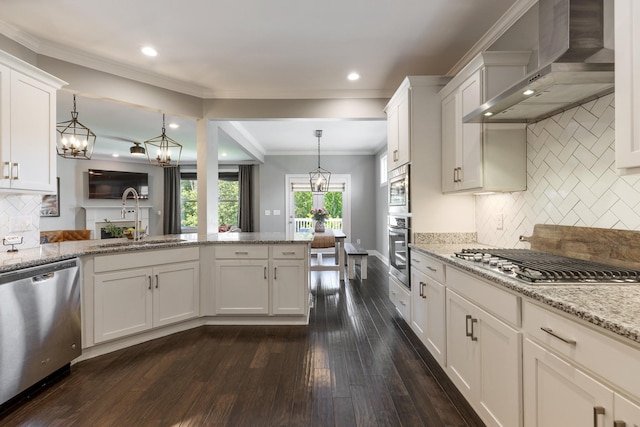 7156 Triple Crown Ln, Fairview, TN 37062 - kitchen with stainless steel appliances, wall chimney range hood, dark wood-style floors, white cabinets, and decorative backsplash
