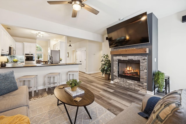 2414 Keegan Dr, Murfreesboro, TN 37130 - living area featuring ceiling fan, light wood-type flooring, and a fireplace
