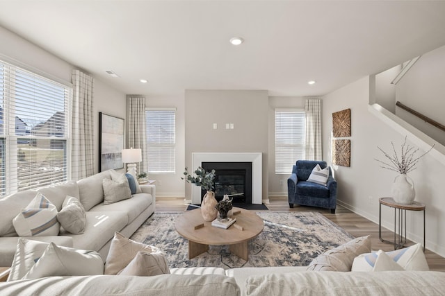 1243 Tucker Dr, Lebanon, TN 37087 - living room with healthy amount of natural light, wood finished floors, a fireplace with flush hearth, recessed lighting, and stairs