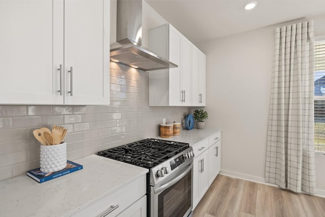1243 Tucker Dr, Lebanon, TN 37087 - kitchen with gas stove, wall chimney range hood, light stone countertops, healthy amount of natural light, and recessed lighting