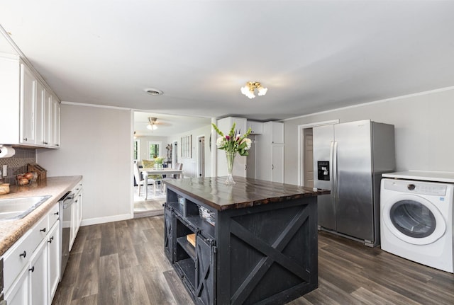 5519 Noble King Rd, Franklin, TN 37064 - kitchen with stainless steel appliances, washer / dryer, wood counters, white cabinets, and dark wood-style floors