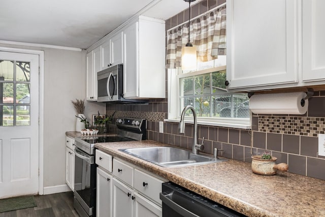 5519 Noble King Rd, Franklin, TN 37064 - kitchen featuring appliances with stainless steel finishes, white cabinets, decorative backsplash, dark wood-style floors, and healthy amount of natural light