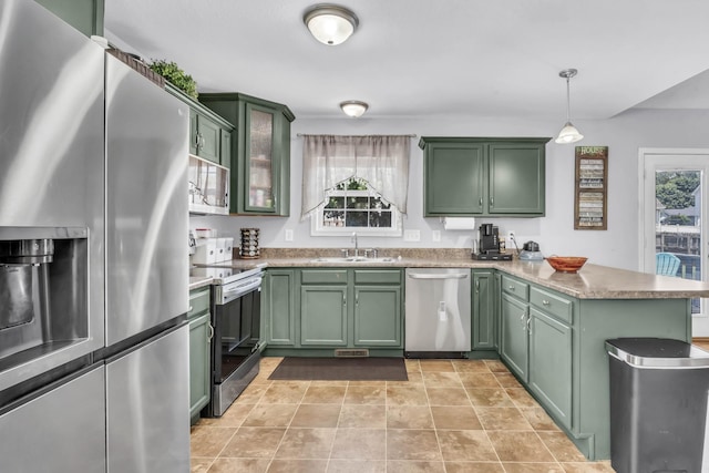 1338 Loren Cir, Clarksville, TN 37042 - kitchen featuring appliances with stainless steel finishes, green cabinetry, a peninsula, pendant lighting, and light countertops