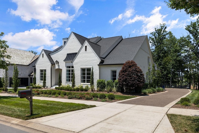 7318 Harlow Dr, College Grove, TN 37046 - french provincial home featuring a front yard and brick siding