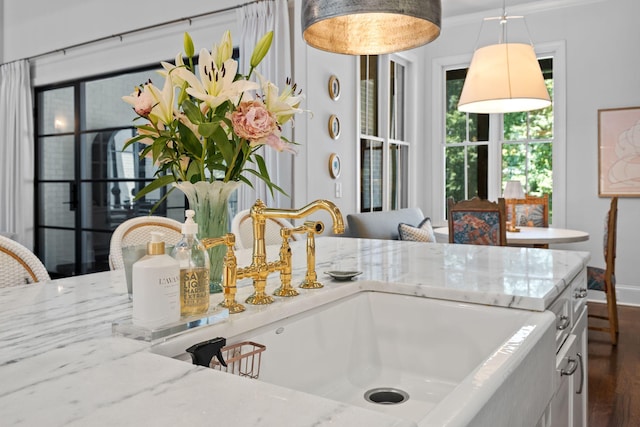 7318 Harlow Dr, College Grove, TN 37046 - kitchen view of light stone counters, pendant lighting, and white cabinetry
