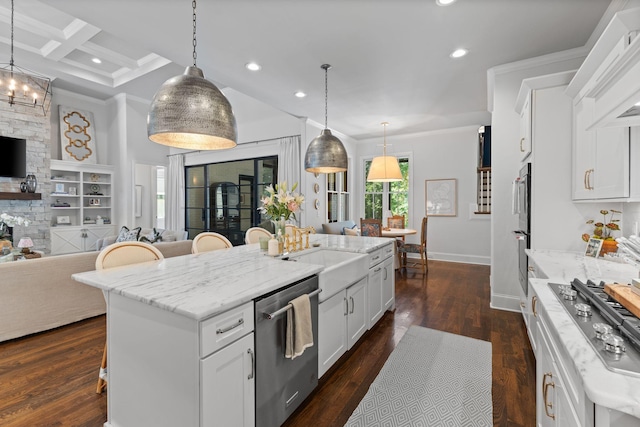 7318 Harlow Dr, College Grove, TN 37046 - kitchen with stainless steel appliances, open floor plan, a kitchen breakfast bar, a kitchen island with sink, and ornamental molding