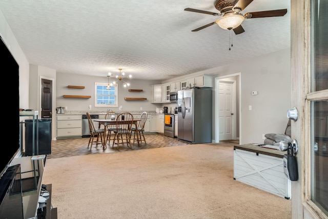183 Caydras Way, Lafayette, TN 37083 - kitchen with stainless steel appliances, open shelves, light colored carpet, a ceiling fan, and white cabinetry