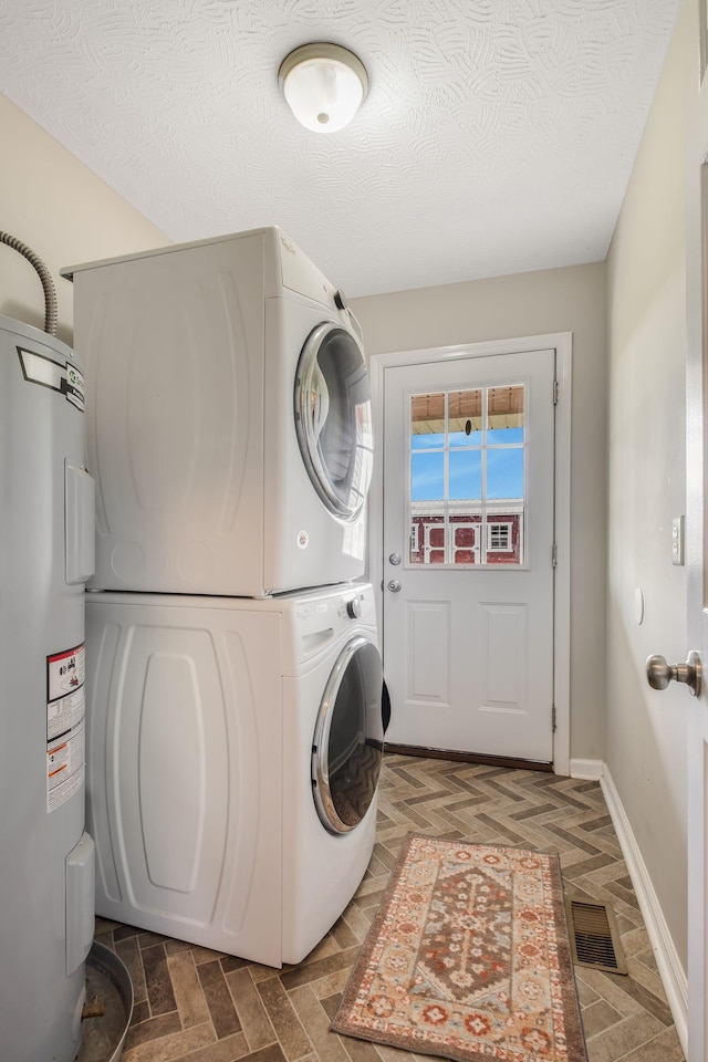 183 Caydras Way, Lafayette, TN 37083 - laundry room featuring stacked washer / dryer and water heater