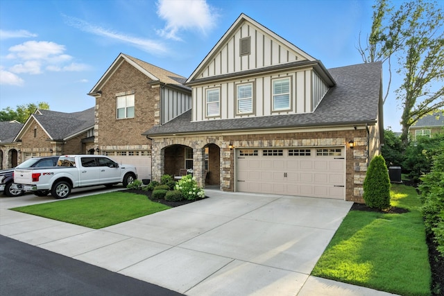 2135 Halfmoon Way, Murfreesboro, TN 37130 - tudor house featuring board and batten siding, concrete driveway, a front yard, a garage, and roof with shingles