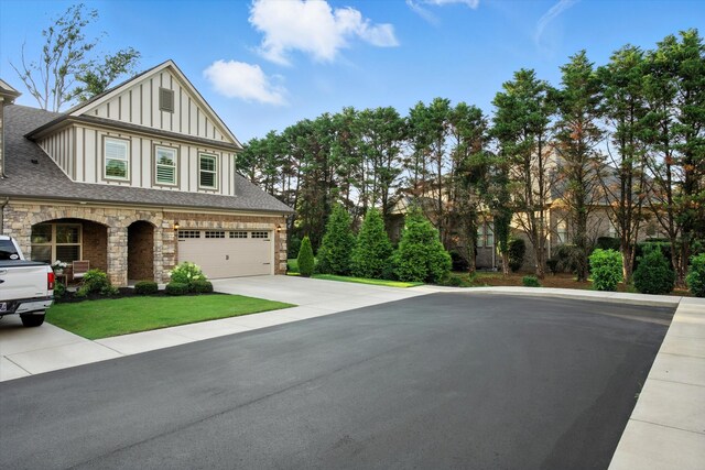 2135 Halfmoon Way, Murfreesboro, TN 37130 - view of front of home with board and batten siding, concrete driveway, stone siding, and a garage