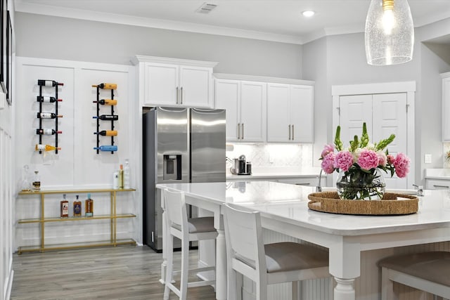 2135 Halfmoon Way, Murfreesboro, TN 37130 - kitchen with stainless steel fridge with ice dispenser, a breakfast bar, white cabinets, ornamental molding, and recessed lighting
