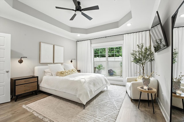 2135 Halfmoon Way, Murfreesboro, TN 37130 - bedroom with light wood-style floors, a tray ceiling, recessed lighting, and a ceiling fan