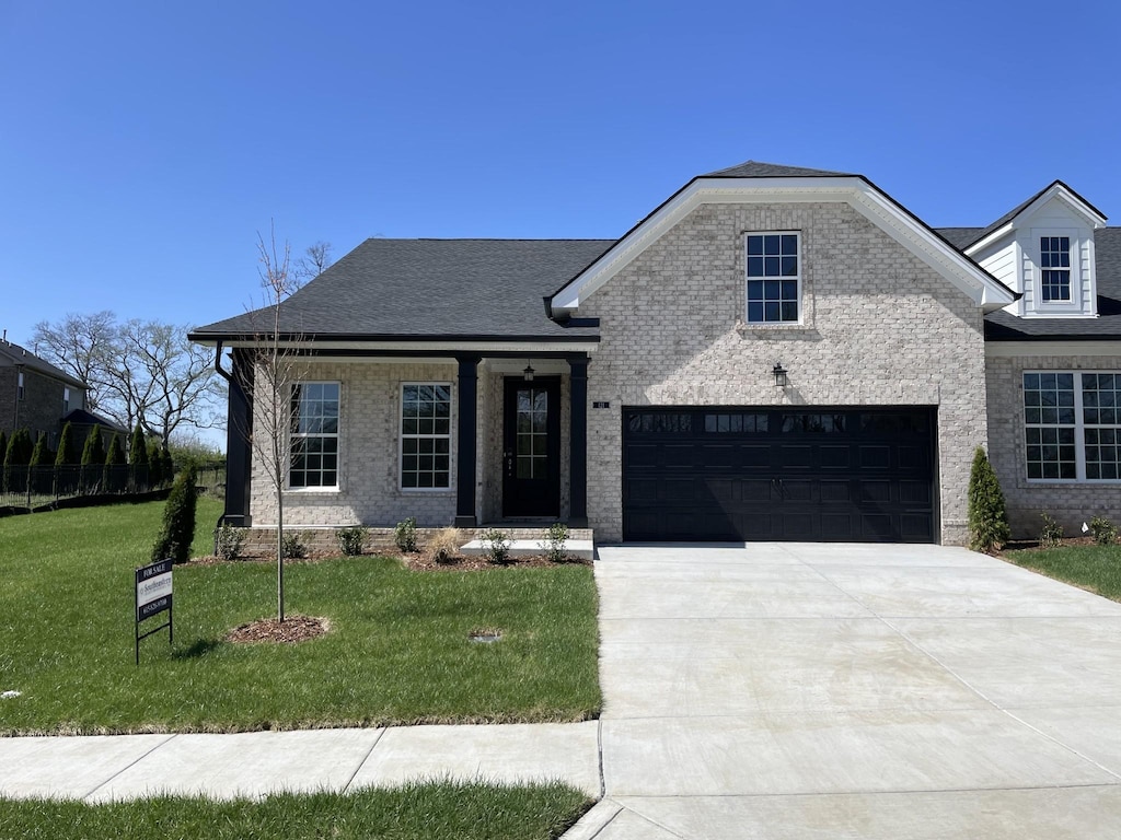 121 Lightberry Ln, Hendersonville, TN 37075 - view of front of property featuring driveway, brick siding, covered porch, and a shingled roof