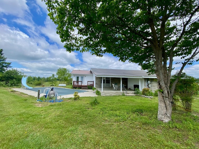 1039 Old Martha Washngton Rd, Clarkrange, TN 38553 - back of house featuring a lawn, a metal roof, and a wooden deck