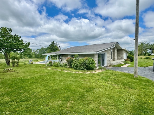 1039 Old Martha Washngton Rd, Clarkrange, TN 38553 - view of side of property with stone siding, a lawn, and a metal roof
