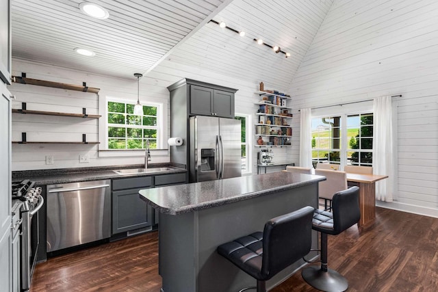 1418 Ridge Rd, Dickson, TN 37055 - kitchen with appliances with stainless steel finishes, open shelves, dark countertops, a breakfast bar, and a high ceiling