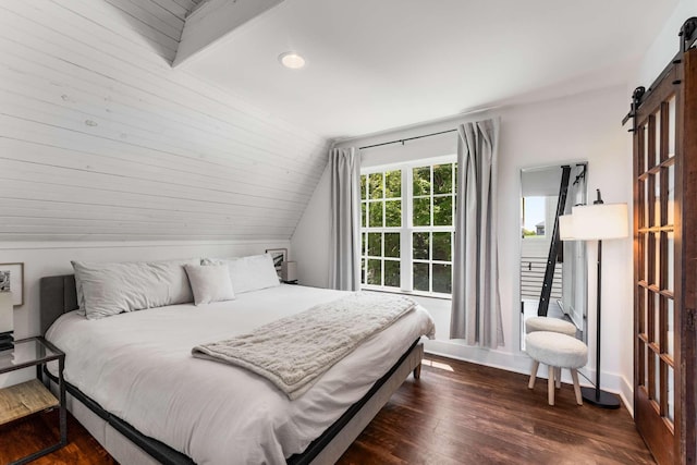 1418 Ridge Rd, Dickson, TN 37055 - bedroom featuring a barn door, lofted ceiling, dark wood-style floors, and recessed lighting