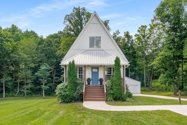 1418 Ridge Rd, Dickson, TN 37055 - view of front of property featuring a front yard, covered porch, a detached garage, and a metal roof