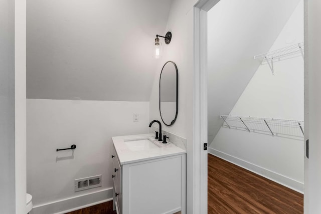 1418 Ridge Rd, Dickson, TN 37055 - bathroom with vanity, wood finished floors, a spacious closet, and lofted ceiling