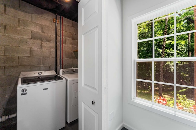 1418 Ridge Rd, Dickson, TN 37055 - laundry room with washing machine and dryer, concrete block wall, and healthy amount of natural light