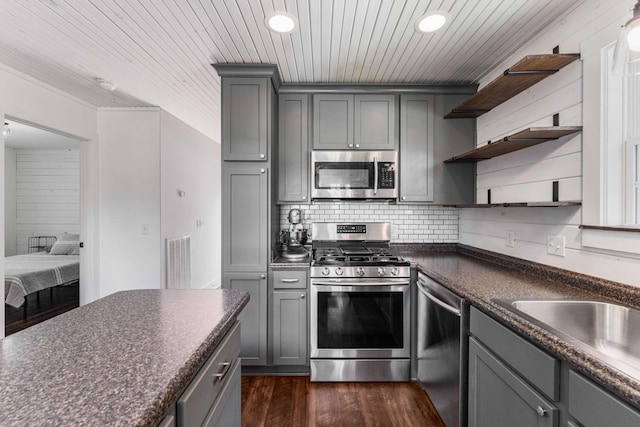 1418 Ridge Rd, Dickson, TN 37055 - kitchen featuring appliances with stainless steel finishes, gray cabinetry, open shelves, dark countertops, and dark wood finished floors
